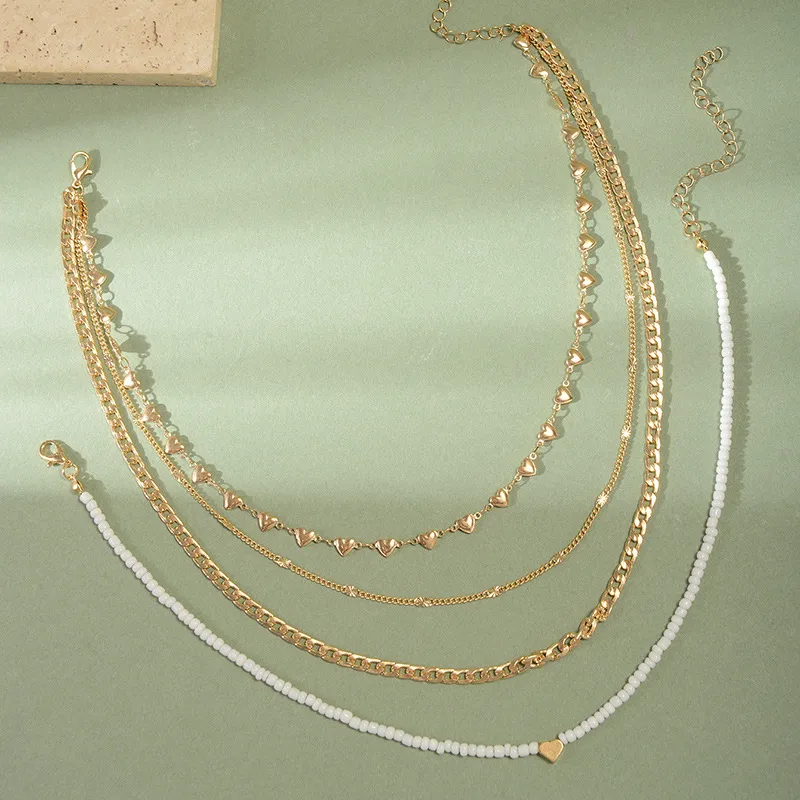 4-Piece Gold Layering Necklace Set – Hearts & Cubans